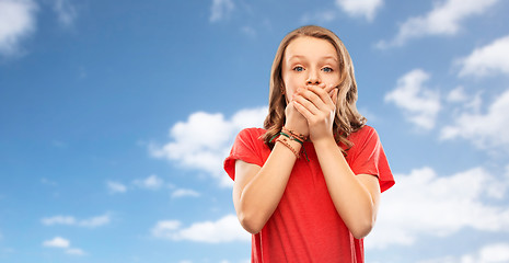 Image showing shocked teenage girl covering her mouth over sky