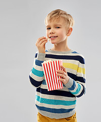 Image showing little boy eating popcorn from paper bucket