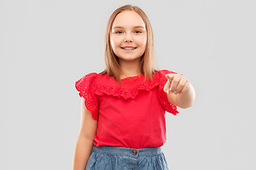 Image showing smiling girl in red shirt pointing to you