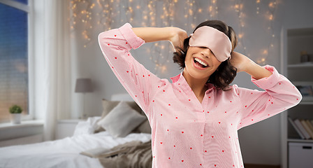 Image showing happy young woman in pajama and eye sleeping mask