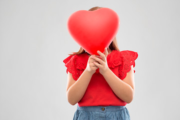 Image showing girl hiding behind red heart shaped balloon