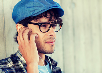 Image showing close up of man with earphones listening to music