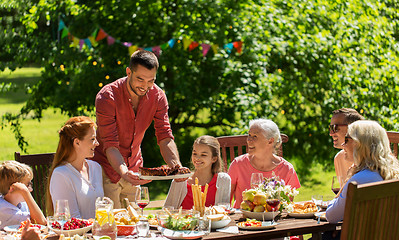 Image showing happy family having dinner or summer garden party