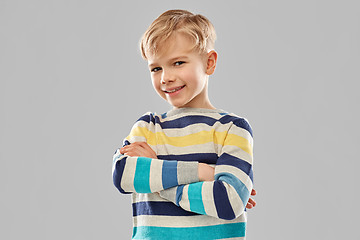 Image showing smiling boy in striped pullover with crossed arms