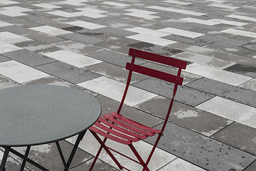 Image showing Outdoor cafe with red chair and table