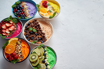 Image showing Various healthy fresh smoothies or yogurts in bowls. With strawberries, kiwi, chia, blackberries