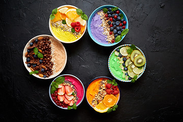 Image showing Various healthy fresh smoothies or yogurts in bowls. With strawberries, kiwi, chia, blackberries