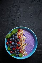 Image showing Healthy food concept. Fresh fruit Blackberries and currants yogurt or smoothie with oat and flakes