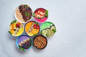 Image showing Various healthy fresh smoothies or yogurts in bowls. With strawberries, kiwi, chia, blackberries