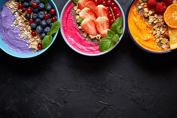 Image showing Various healthy fresh smoothies or yogurts in bowls. With strawberries, kiwi, chia, blackberries