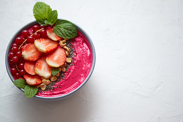 Image showing Summer berry smoothie or yogurt bowl with strawberries, red curr