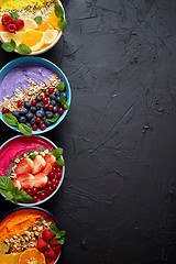 Image showing Various healthy fresh smoothies or yogurts in bowls. With strawberries, kiwi, chia, blackberries