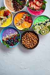 Image showing Various healthy fresh smoothies or yogurts in bowls. With strawberries, kiwi, chia, blackberries