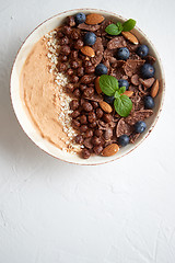 Image showing Chocolate and blueberry smoothie or yogurt. With cocoa cornflake