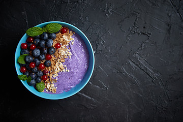 Image showing Healthy food concept. Fresh fruit Blackberries and currants yogurt or smoothie with oat and flakes