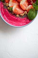 Image showing Summer berry smoothie or yogurt bowl with strawberries, red curr