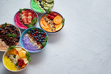 Image showing Various healthy fresh smoothies or yogurts in bowls. With strawberries, kiwi, chia, blackberries