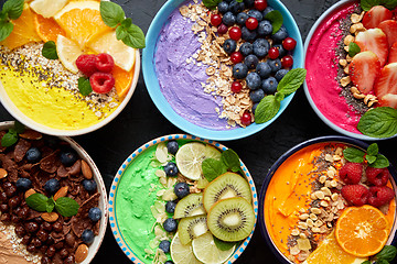 Image showing Various healthy fresh smoothies or yogurts in bowls. With strawberries, kiwi, chia, blackberries