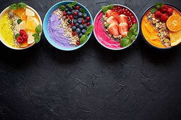 Image showing Various healthy fresh smoothies or yogurts in bowls. With strawberries, kiwi, chia, blackberries