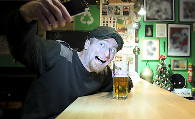 Image showing Guy and phone in the bar