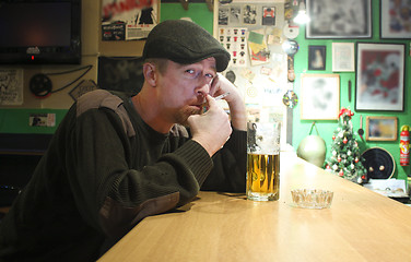 Image showing Guy smokes in the bar