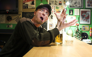 Image showing Guy smokes in the bar