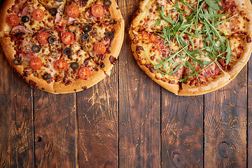 Image showing Composition of two various kinds pizzas on wooden table