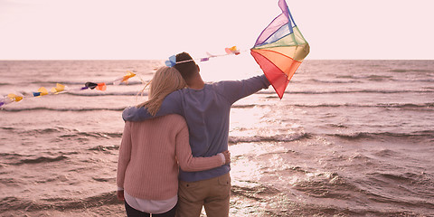 Image showing Happy couple having fun with kite on beach