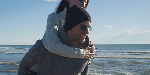 Image showing couple having fun at beach during autumn