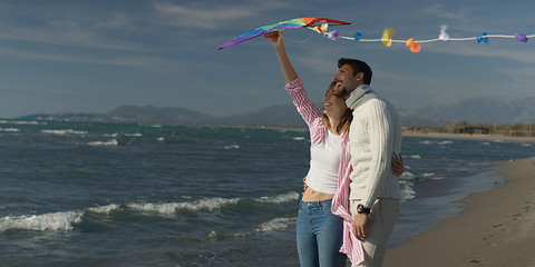 Image showing Happy couple having fun with kite on beach