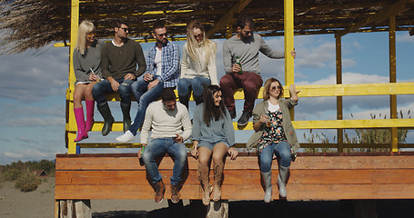 Image showing Group of friends having fun on autumn day at beach