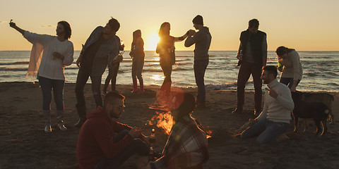 Image showing Friends having fun at beach on autumn day