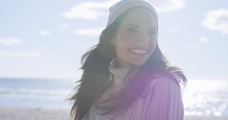 Image showing Girl In Autumn Clothes Smiling on beach