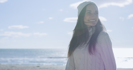 Image showing Girl In Autumn Clothes Smiling on beach