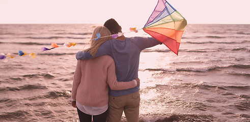 Image showing Happy couple having fun with kite on beach