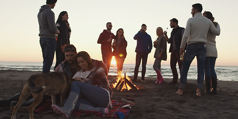 Image showing Friends having fun at beach on autumn day