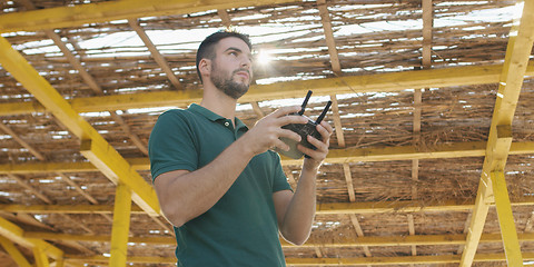 Image showing Man Operating Drone By The Sea