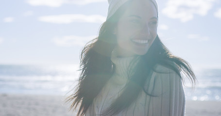 Image showing Girl In Autumn Clothes Smiling on beach