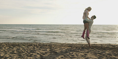 Image showing Loving young couple on a beach at autumn on sunny day