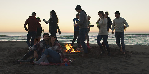 Image showing Friends having fun at beach on autumn day