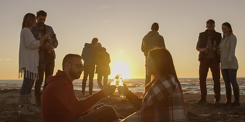 Image showing Friends having fun at beach on autumn day