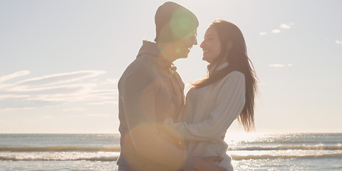 Image showing Couple having fun on beautiful autumn day at beach