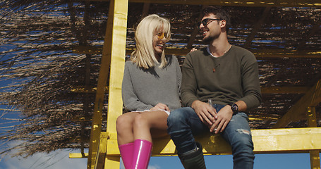 Image showing Couple drinking beer together at the beach