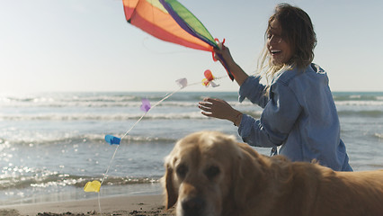 Image showing Woman holding kite at beach on autumn day