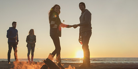 Image showing Friends having fun at beach on autumn day