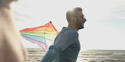 Image showing Happy couple having fun with kite on beach