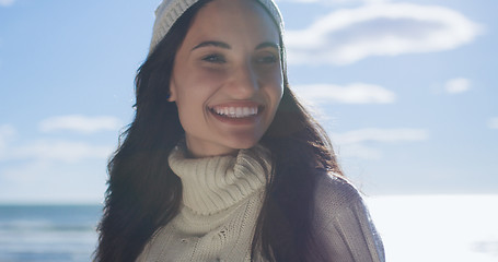 Image showing Girl In Autumn Clothes Smiling on beach