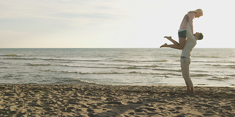 Image showing Loving young couple on a beach at autumn on sunny day