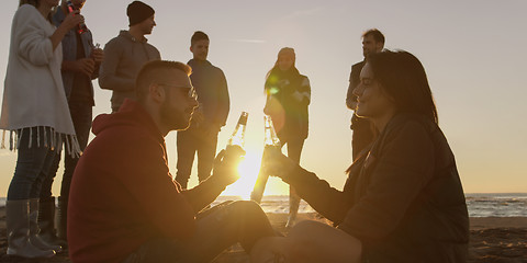 Image showing Friends having fun at beach on autumn day