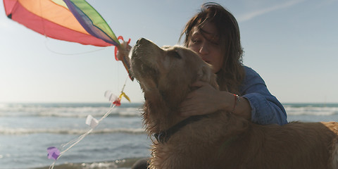 Image showing Woman holding kite at beach on autumn day